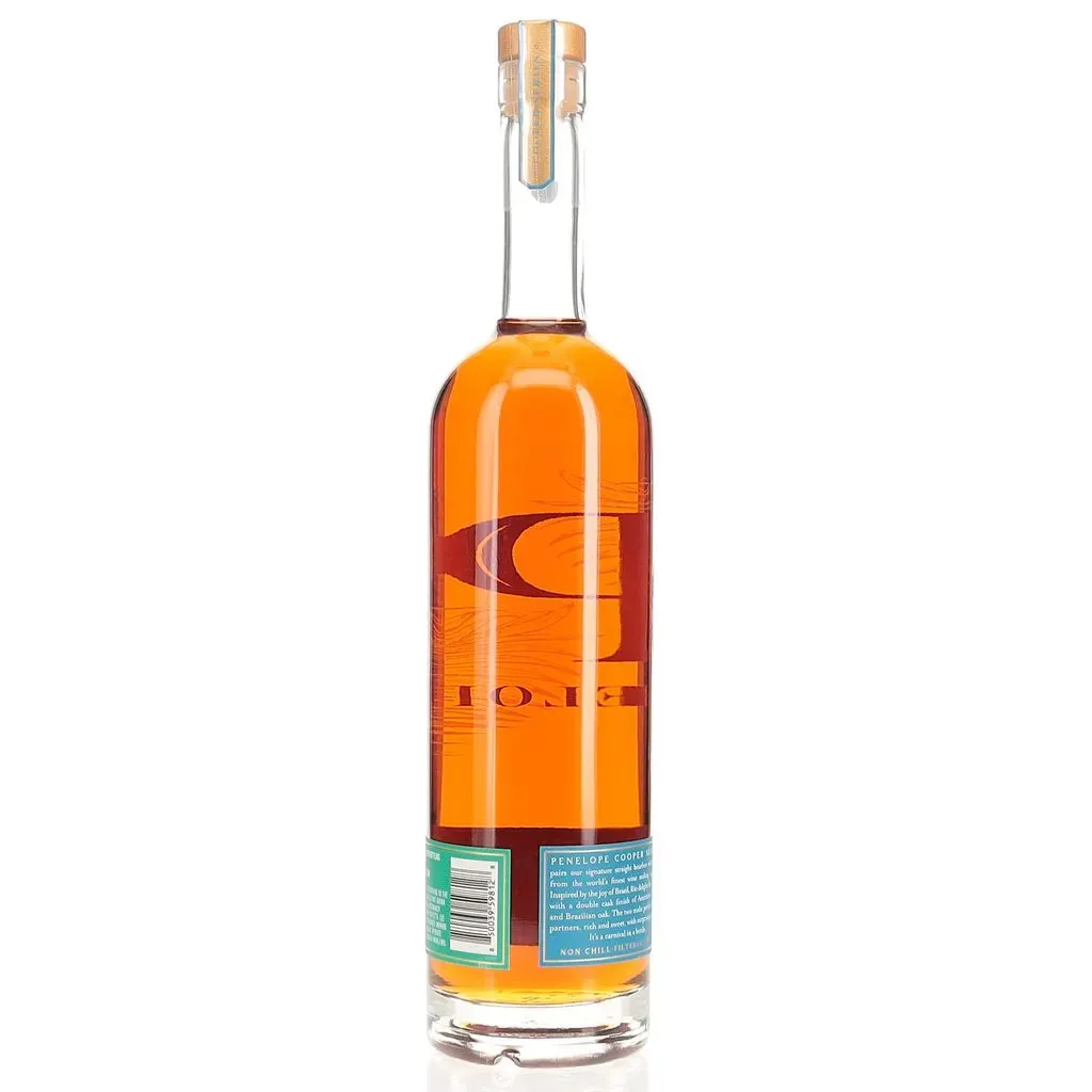 Penelope Rio Bourbon is an innovative and exciting release from Penelope Bourbon's Cooper Series, which explores unique cask finishes from around the world. This 2024 edition showcases a double cask finish, combining American honey barrels and Brazilian Amburana wood to create a truly distinctive flavor profile.

Bottled at 98 proof (49% ABV), this straight bourbon whiskey offers a captivating sensory experience. On the nose, it presents enticing aromas of sweet honey, burnt wood, cinnamon potpourri, and cedar, with hints of burnt orange rind and dark fruit. The palate is equally complex, featuring flavors reminiscent of Greek baklava, charred marshmallow, and a harmonious blend of sweet and savory notes.

As the whiskey develops, it reveals layers of graham cracker, cinnamon stick, cream soda, and roasted malt. The finish is full-bodied and lingering, with a perfect balance of sweetness and spice. Penelope Rio Bourbon manages to improve upon its already popular predecessor, offering bourbon enthusiasts a unique tasting experience that captures the vibrant spirit of Brazil.
